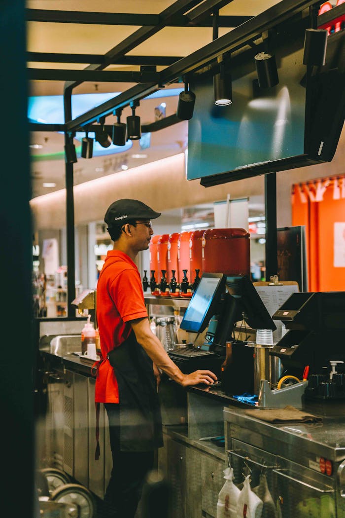 Young waiter working at a fast food counter in a Kuala Lumpur restaurant.
